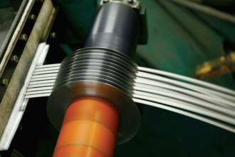Close up of stainless steel coil slitting process